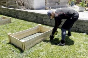 Using a sawsall to cut grass around a garden bed