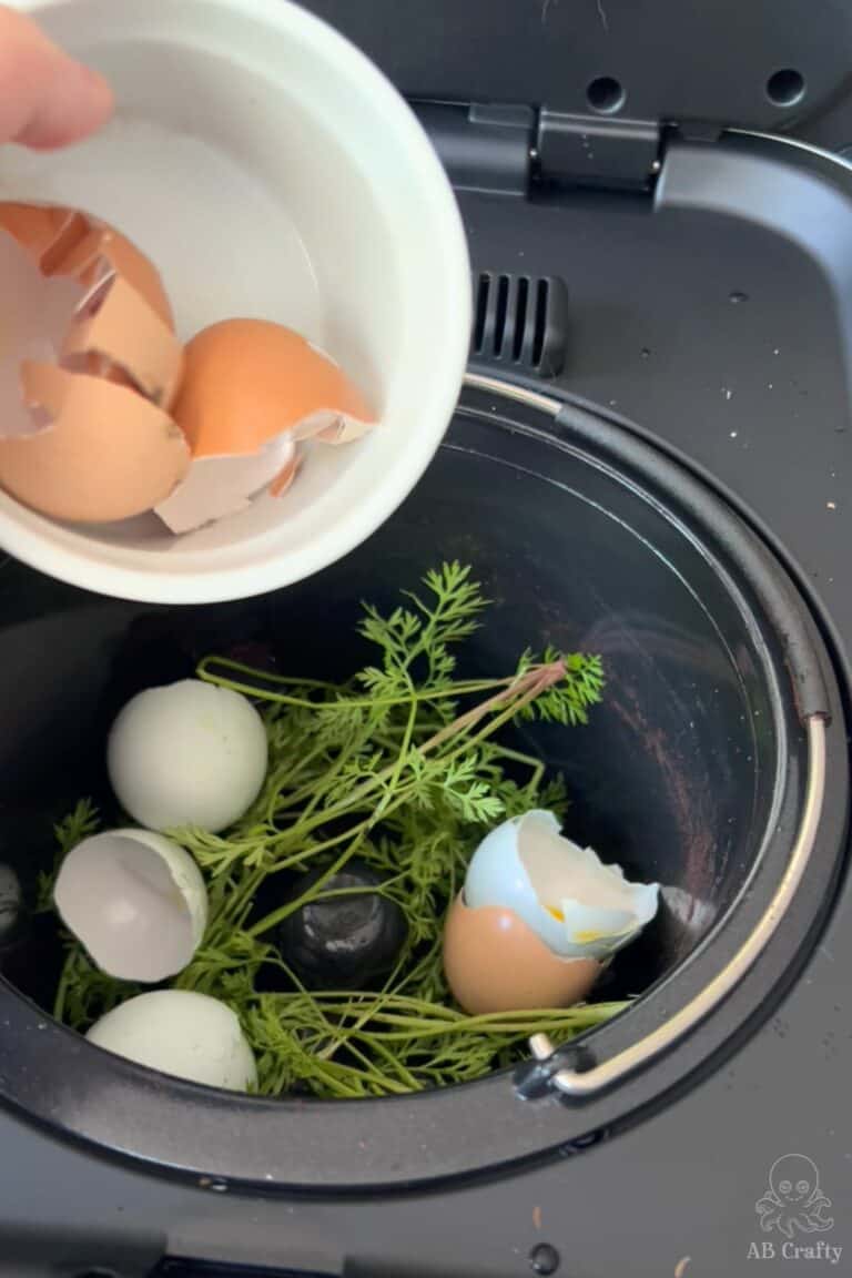 adding egg shells to a food composter containing carrot tops