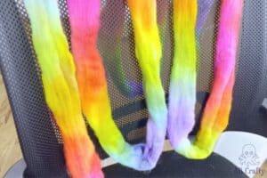 rainbow dyed wool draped over the back of an office chair