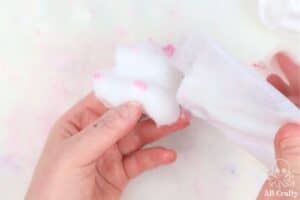 pouring white flocking powder on a DIY taba squishy hamster