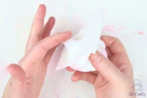 finger showing how sticky the bottom of a mold filled with silicone is