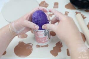 taping a ball to a yoplait yogurt container