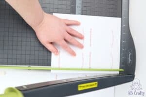 using a paper cutter to cut the valentine's cards